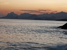 Sunset view over calm water with mountains FREE Stock Photo, sunset,  calm water,  mountains picture